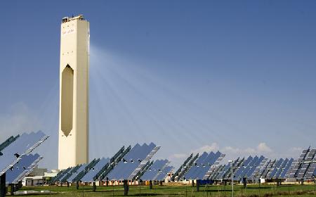 A solar power tower in Spain.  Solar panels distributed around the tower focus light onto a receiver at the top, which heats a fluid which can then be used to power a generator.