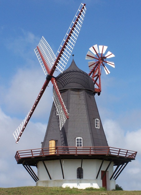 A windmill in Soenderho, Fanoe,
Denmark.  The whole mill can rotate. It has a fantail to keep it
pointed in the direction of the prevailing wind, thus maximising the
volume of air passing it.